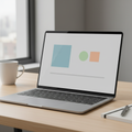Laptop showing a clean minimalist presentation slide layout on a desk