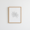 Framed minimalist city-map line print on a bright wall, abstract streets